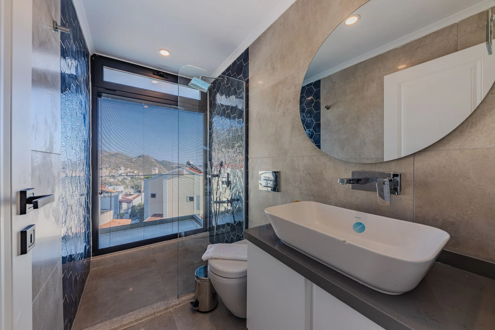 Bathroom basin and mirror beside a window