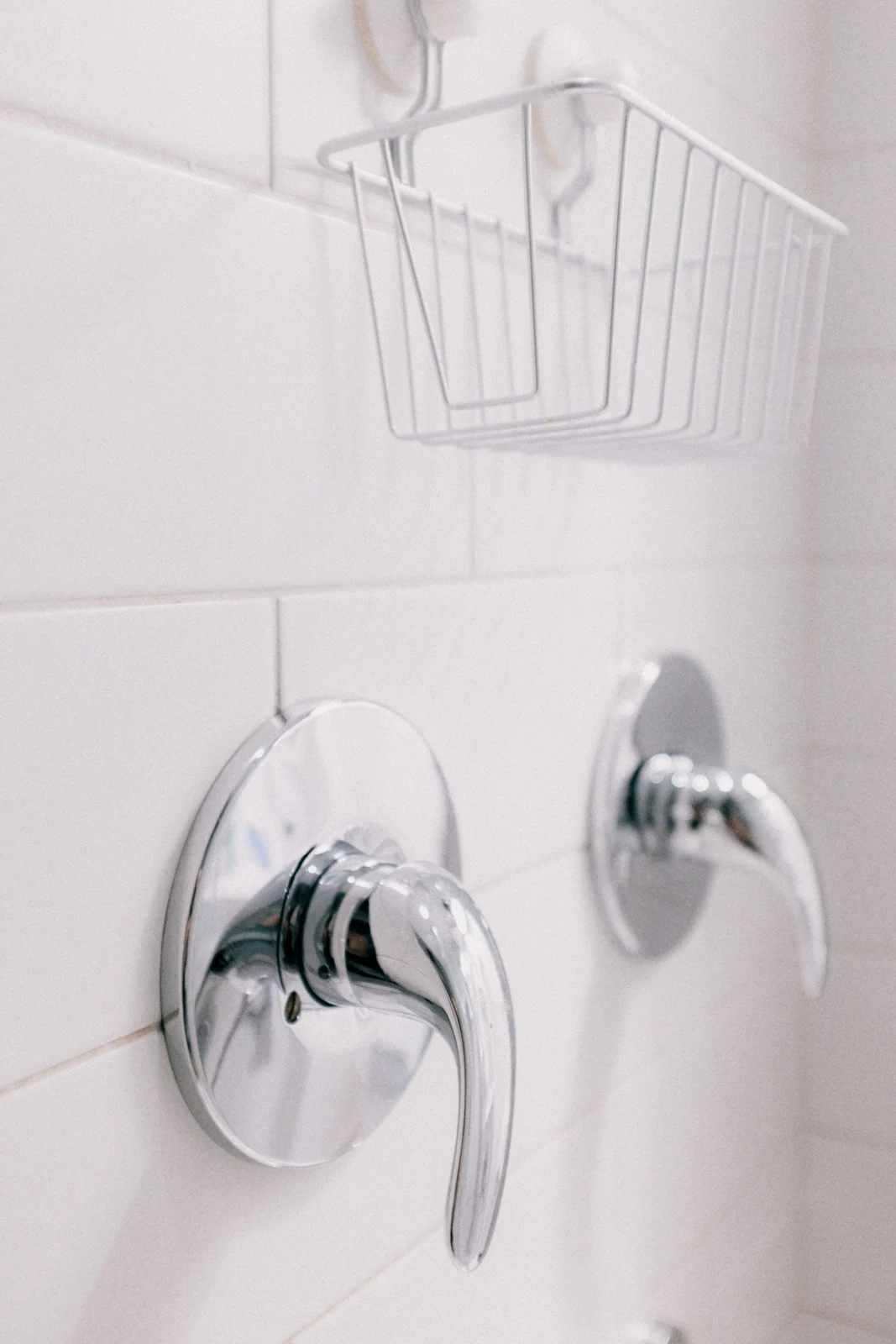 Close-up of chrome bathroom fixtures with a clean, minimalist design
