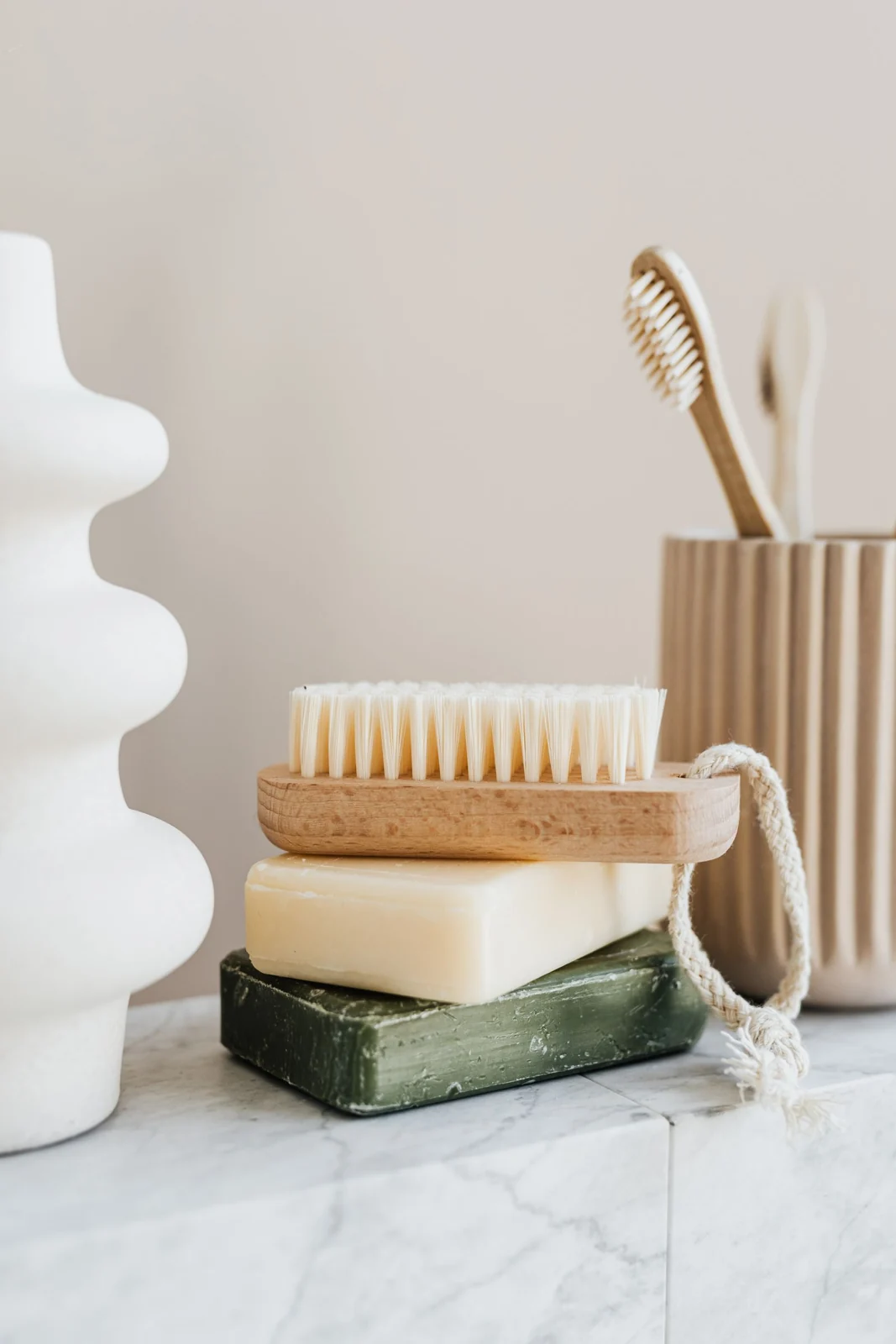 Bathroom brushes and soap beside a basin