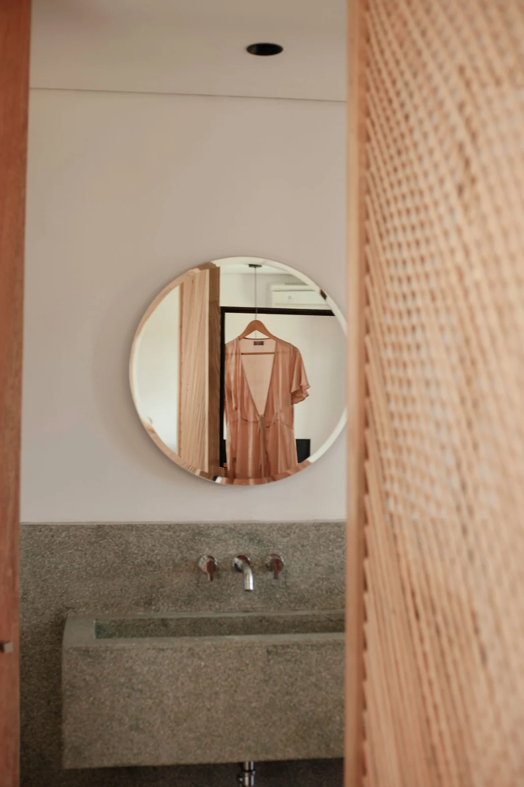 Round mirror above a bathroom basin