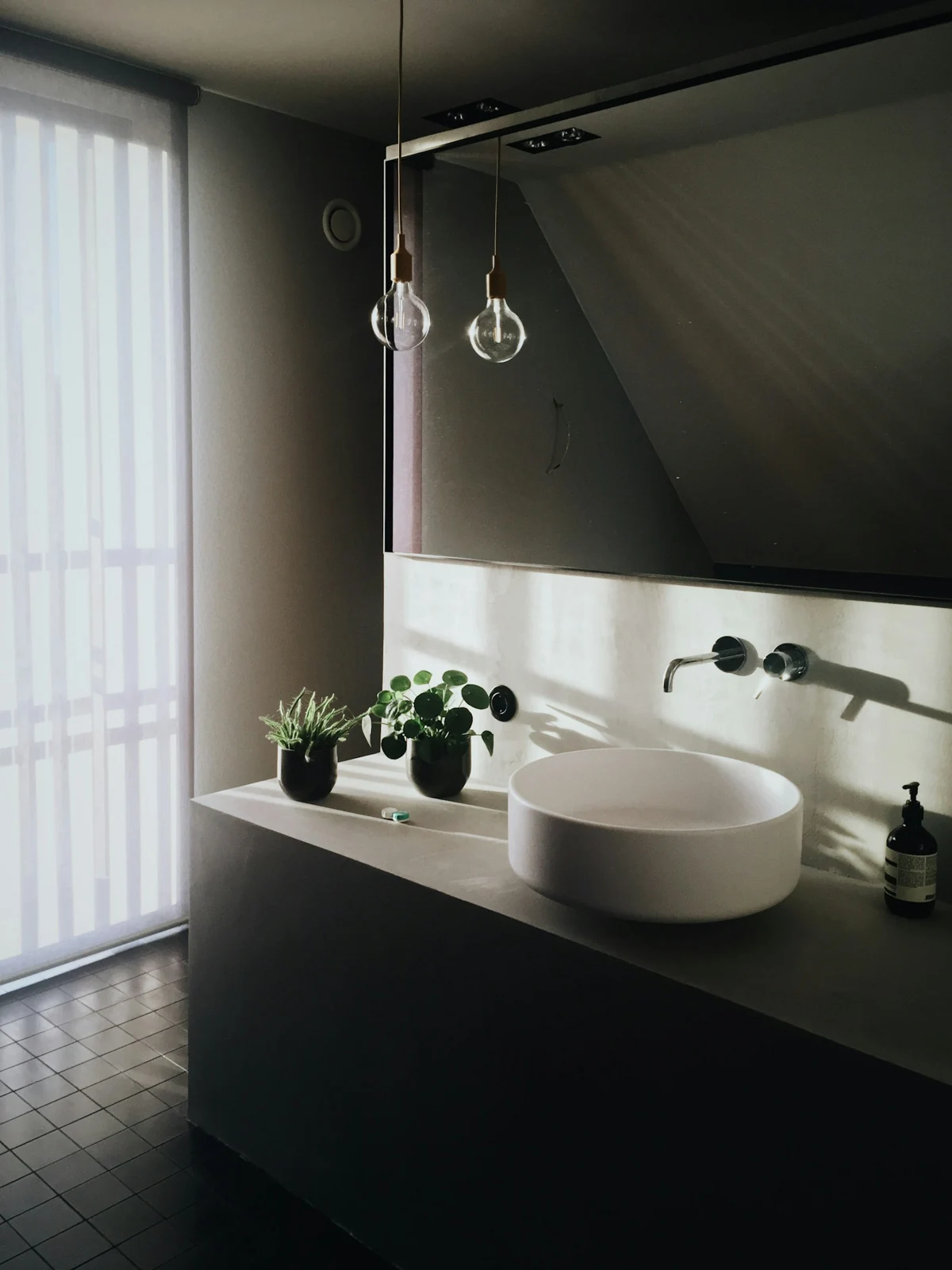Bathroom basin beneath a wall mirror